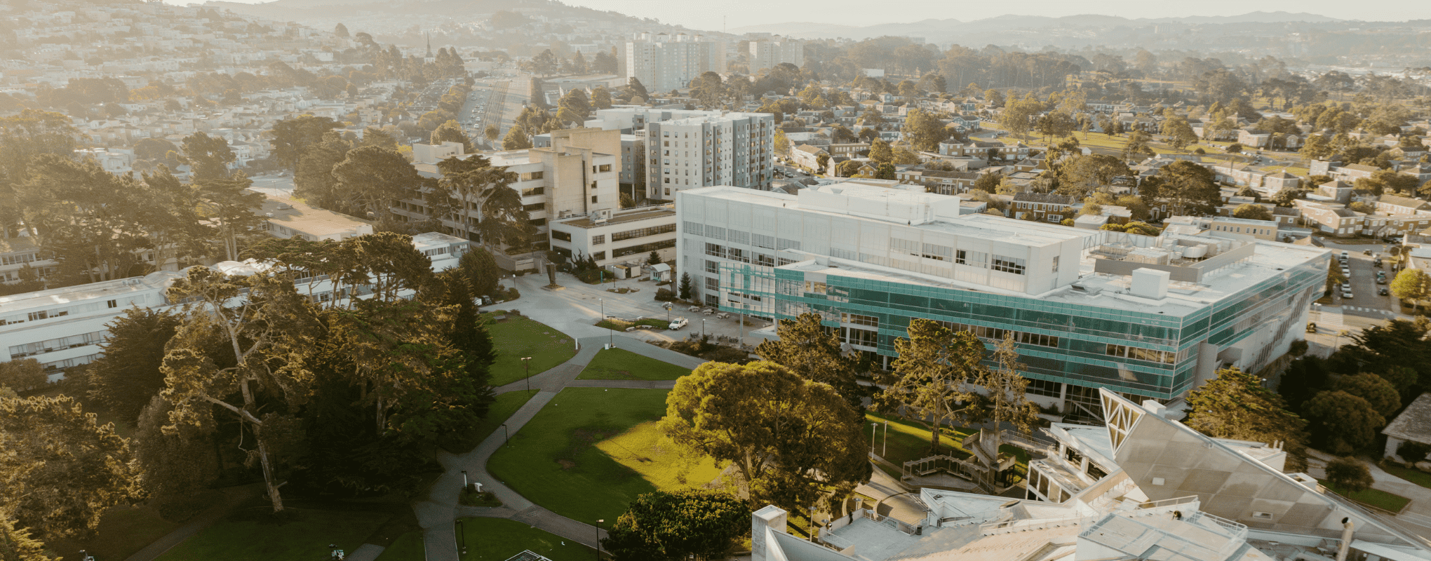 SFSU from an areal view showing grass, trees, the library and some other buildings