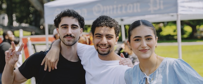 Three SFSU students together at a tabling event in the Quad