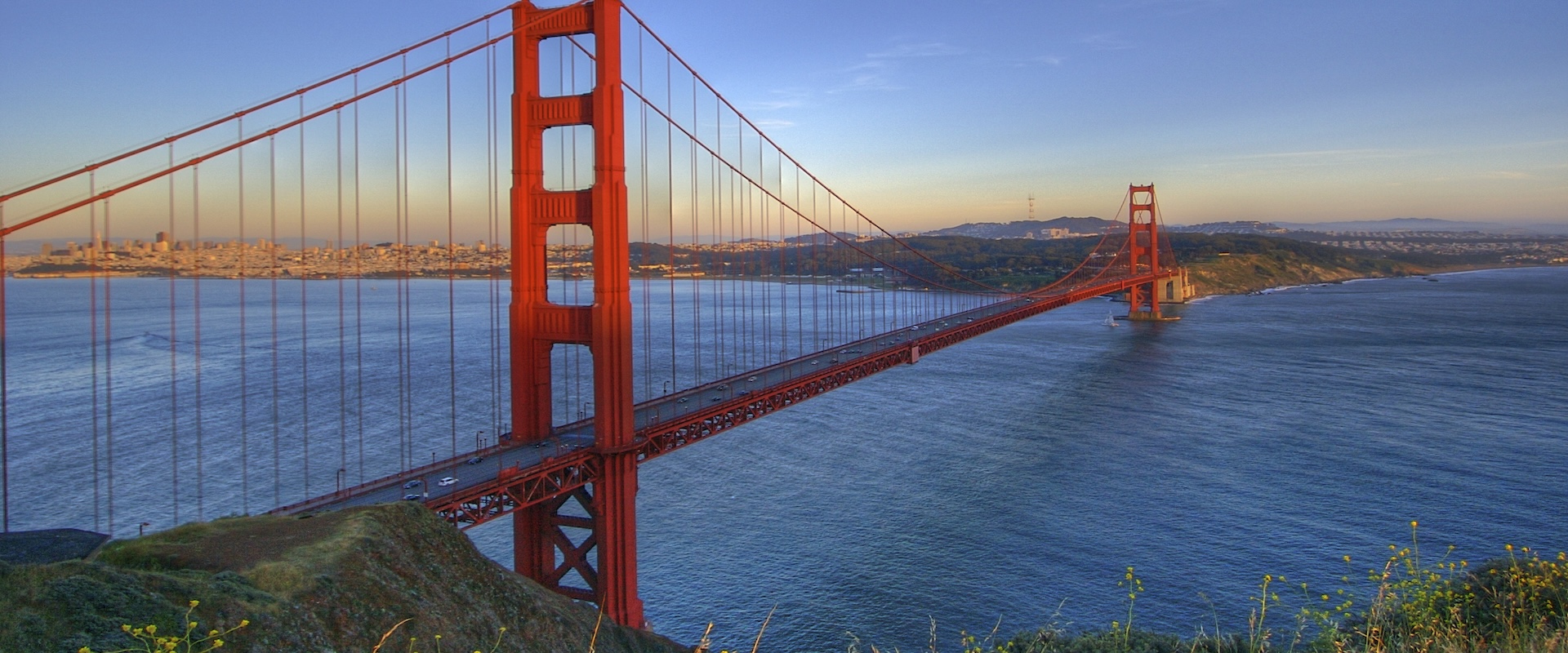 San Francisco bay bridge with fields, ocean and city from afar