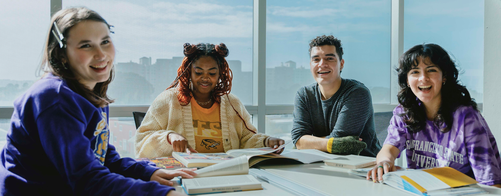 Four students working together at a room in the SFSU Library